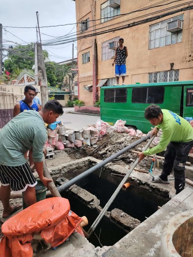 Crew clearing a septic line on-site