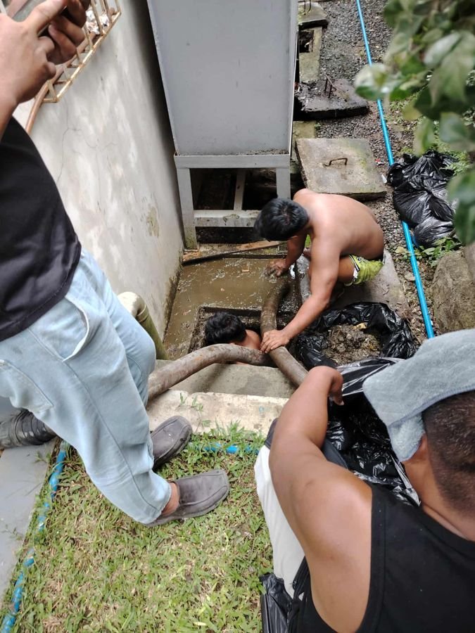 Siphoning hose lowered into the tank